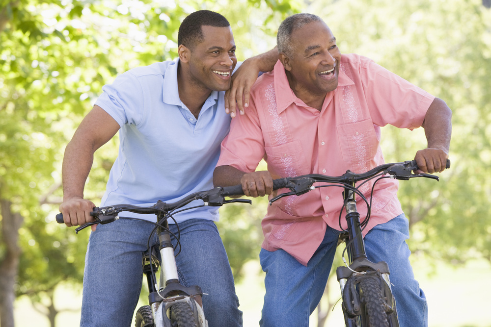 Two men riding bikes together