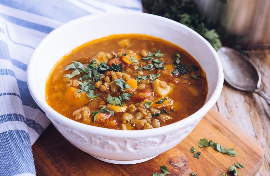 bowl of lentil soup on a wooden background