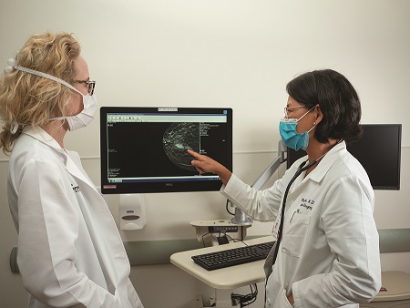 Surgeons pointing at screen