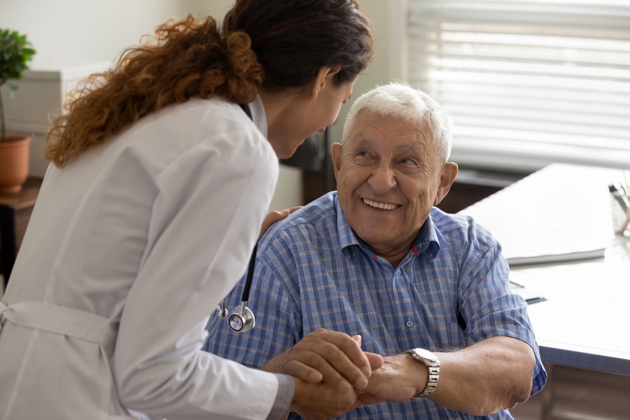 Male patient shaking a female doctors hand