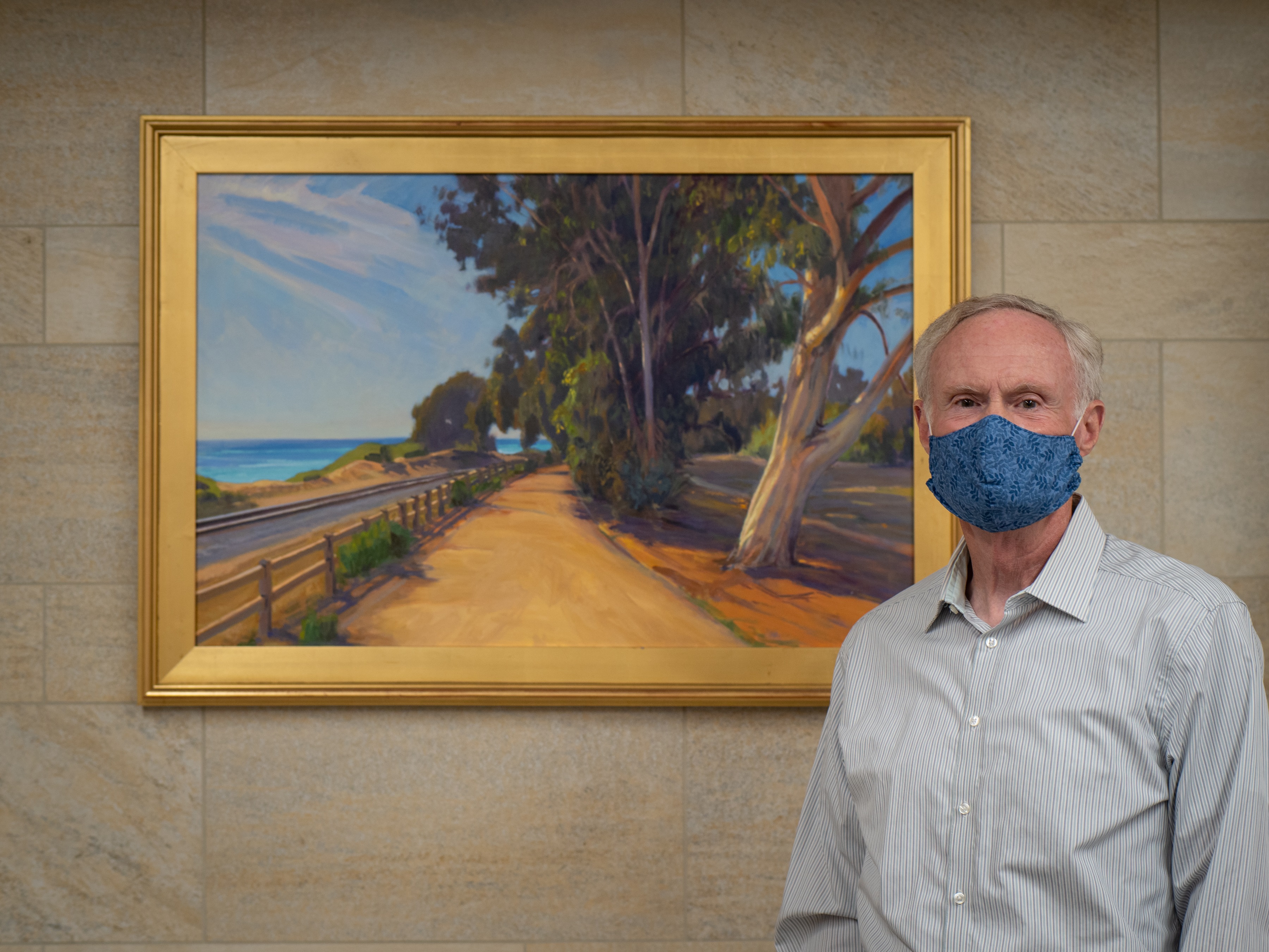 Patient Michael Miller in front of a painting