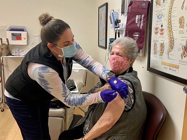 Medical assistant administering vaccine
