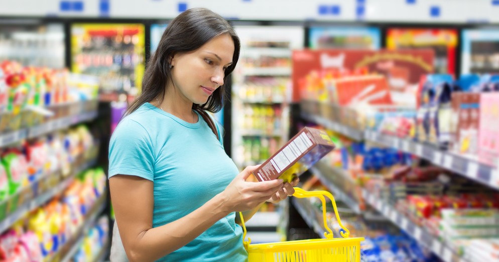 woman reading box label for nutrition
